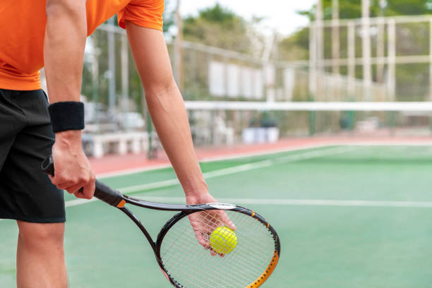 tennis player play tennis sport by hit tennis ball with tennis racket in tennis court and stadium for tennis challenge tournament for health and exercise stock photo
