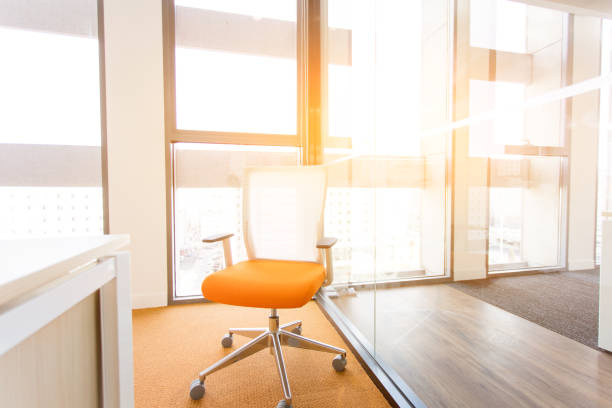 istock Early morning light shines into the office with a chair 1453915944