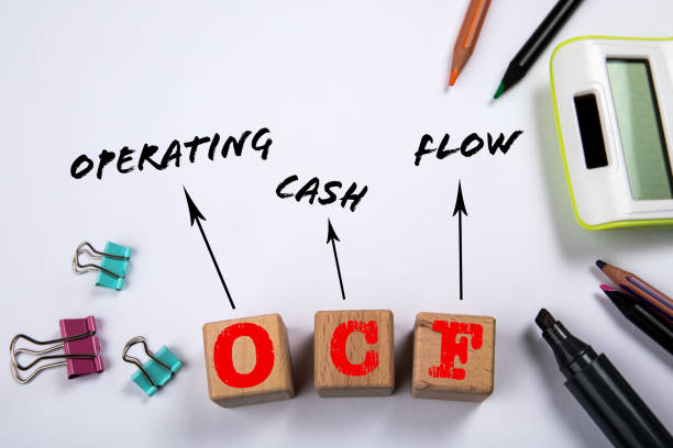 istock OCF - Operating Cash Flow. Wooden blocks on a white office table 1453917140