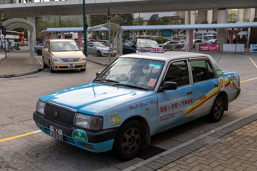 Hong Kong - January 2, 2023 : Blue Taxi in Tung Chung, Lantau Island, Hong Kong. The Blue Taxis are just found on Lantau Island and basically operate and serve there.