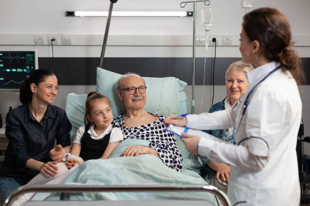 istock Practitioner doctor monitoring elderly sick old patient explaining disease symptoms 1453917276