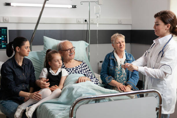 istock Practitioner doctor monitoring elderly sick old patient explaining disease symptoms 1453917358