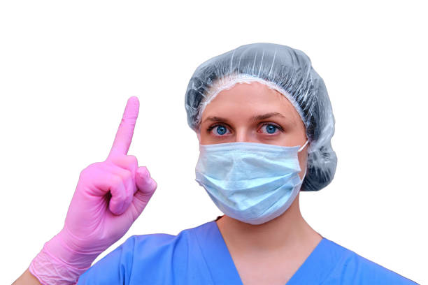 Smiling masked nurse over blue background.