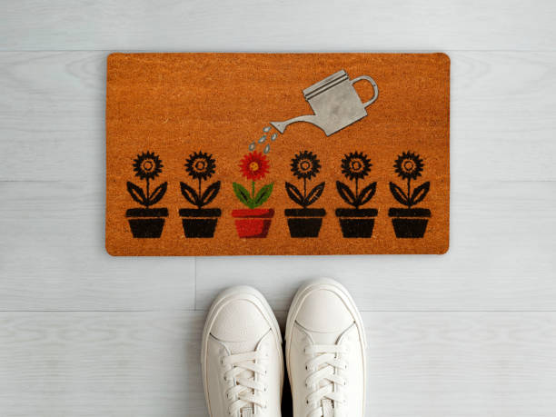 istock Designer Welcome Entry Doormat Placed on White Floor with White Shoes 1453920187