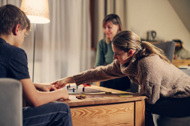 istock Family playing large modern board game together at home 1453922254