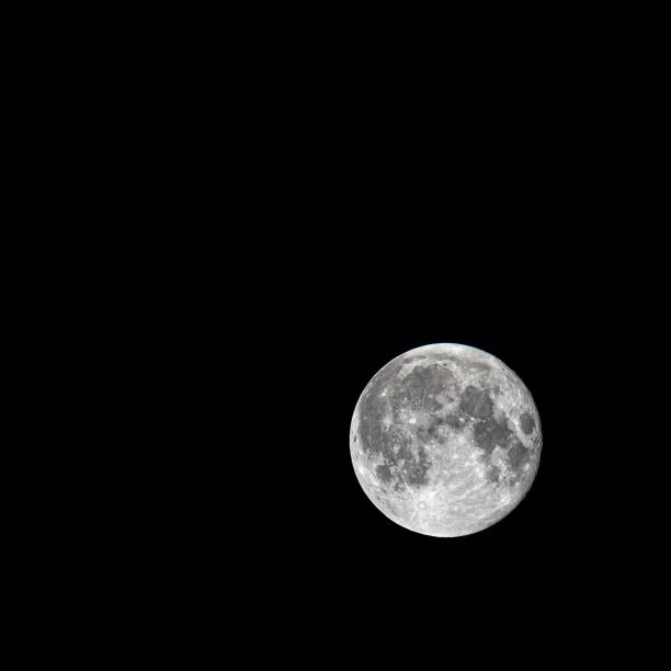 istock Pale full moon isolated on black background, close-up 1453922948