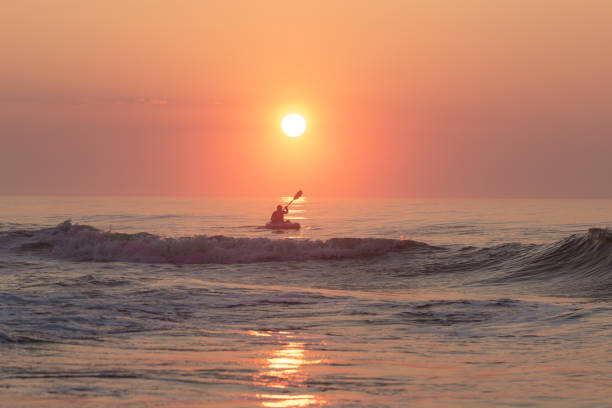 istock Man on the sailing boat during sunset 1453926041