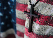 istock Small wooden cross and flag of USA. God save America 1453926054