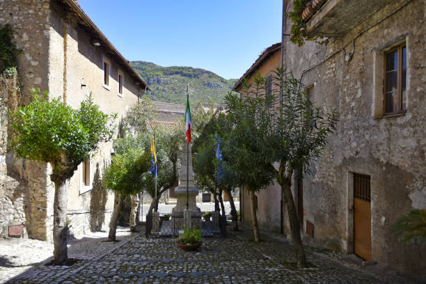 Small street with flags in the historic town of Sermoneta, central Italy A small street with flags in the historic town of Sermoneta, central Italy village lazio photography sermoneta stock pictures, royalty-free photos & images