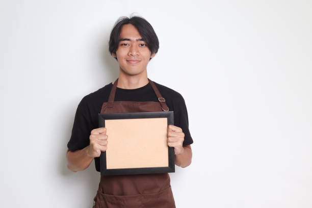 istock Asian barista man  holding an empty frame board 1453926881