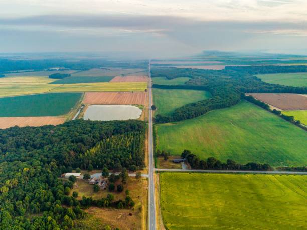 istock bird's eye view of plowed fields on a sunny day 1453927102