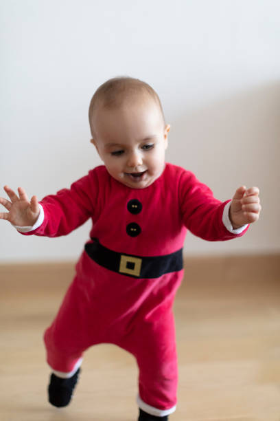 istock Baby girl learning to walk before Christmas 1453930437