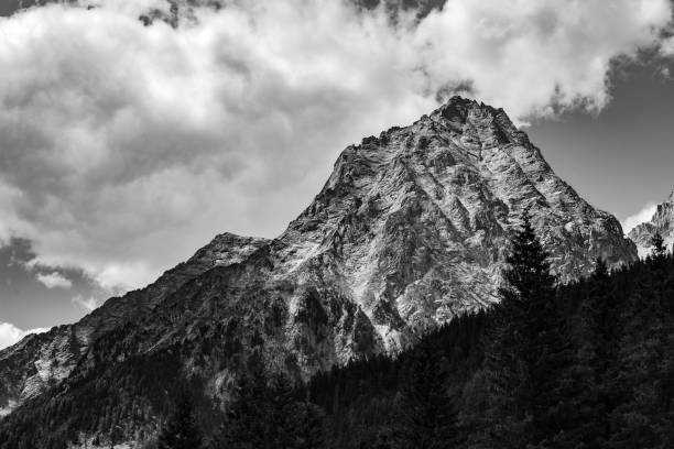 istock Greyscale shot of a mountain landscape with a cloudy sky 1453930934