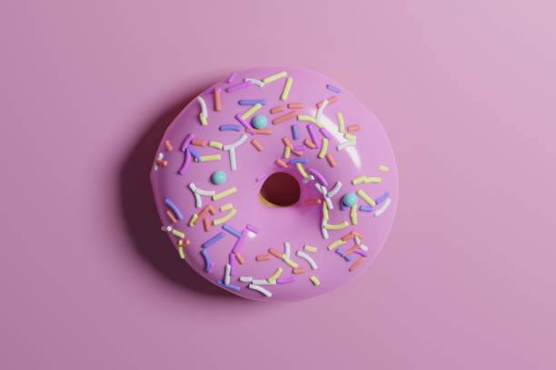 istock 3D rendering of a doughnut with colorful sprinkles on a pink background 1453932398