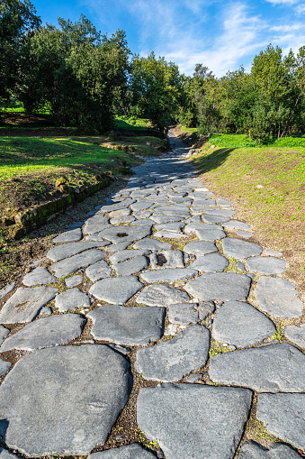 An ancient cobbled street in the Roman city of Cumae at Cumae archaeological park, Pozzuoli, Italy