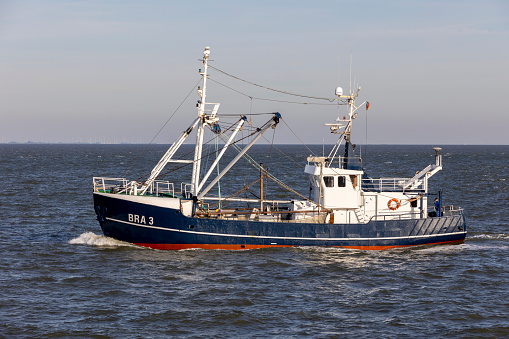 Cuxhaven, Germany – October 09, 2021: A shrimp boat sailing on the river Elbe in Germany