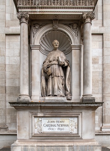 London, United Kingdom – August 16, 2022: A vertical shot of a statue of John Henry Cardinal Newman outside the Brompton Oratory in London, United Kingdom