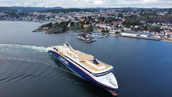 Larvik, Norway – October 21, 2022: An drone shot of superspeed 2 docking to Larvik Harbour with the city in the background
