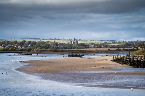 A distant view of the Warkworth Castle from Amble Harbor, Northumberland, England