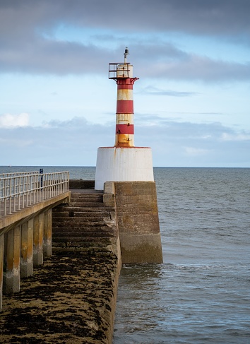 A vertical shot of a lighthouse at the coast in Amble, Northumberland, England
