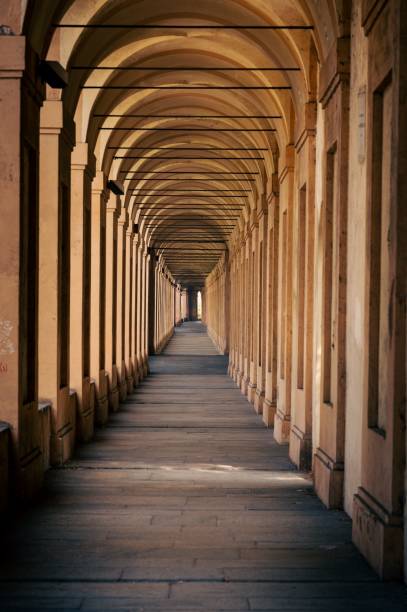vertical shot of 666 arches in portici di bologna towards santuario madonna di san luca in italy - madonna imagens e fotografias de stock