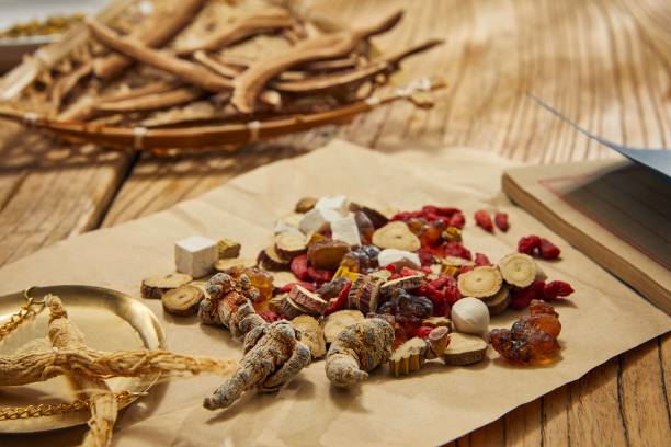 istock Selective focus of some chopped herbs and nuts on a brown parchment on a mahogany table 1453933983