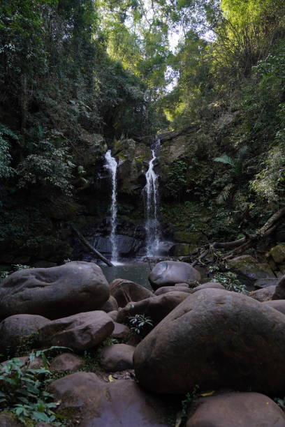 istock Vertical shot of a thin waterfall flowing down huge rocks. 1453935179