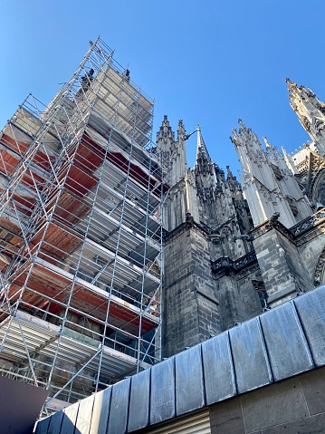 A vertical low angle shot of scaffolding at Cologne Cathedral, Germany