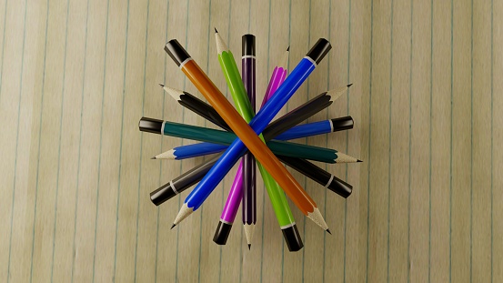 A top view of a set of colorful pencils on a striped background