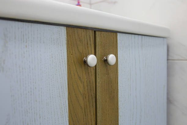 istock Close-up of two small round doorknobs on a bathroom cabinet 1453936728