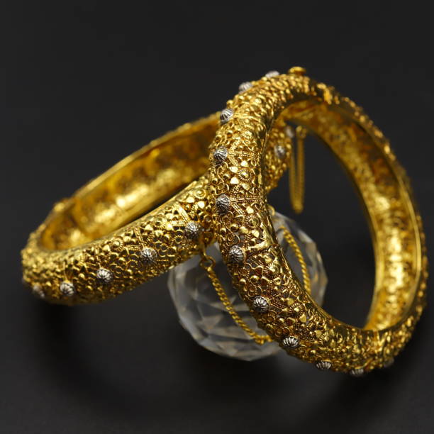 istock Closeup of golden bangles on a black background 1453939900