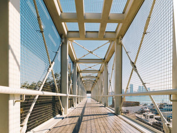 istock Closeup of a white metal bridge with a blue sky background 1453939949