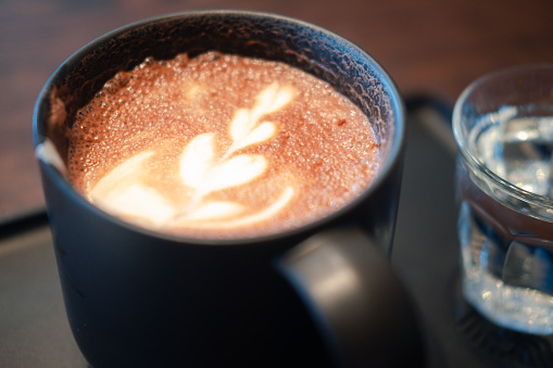 Hot mocha - a cup of hot coffee with beautiful latte art, Morning Breakfast.