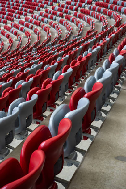 istock Rows of empty white and red chairs in a football stadium. 1453941642