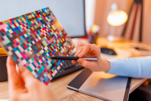 istock Designer choosing color from color palette while working 1453942391