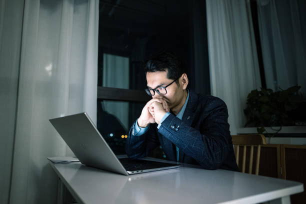 istock Businessman overworked at night 1453943075