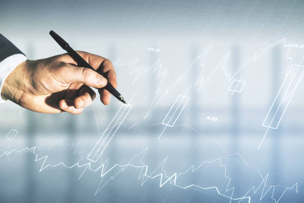istock Man hand with pen working with abstract virtual financial graph on blurred office background, financial and trading concept. Multiexposure 1453943859
