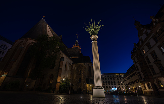 Leipzig, Germany - July 02, 2022: The city Center of the saxony metropolis at night. St. Nicholas Church or Nikolaikirche illuminated. One of the major churches at Leipzig. Peaceful demonstrations