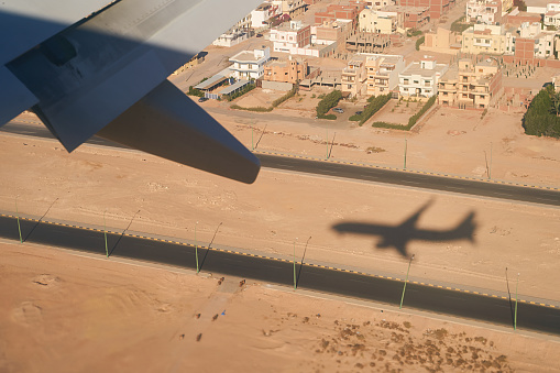 Shadow of a plain landing in the city of Sharm El Sheikh, Egypt