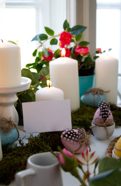istock White candles and festive easter eggs and white card copy space 1453945257
