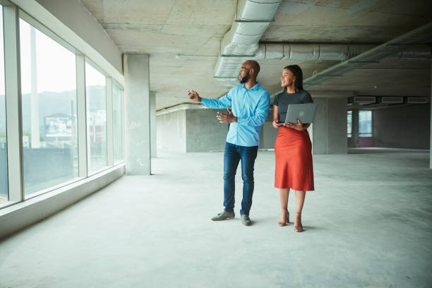 istock Architects talking during an inspection of an interior building site 1453946158