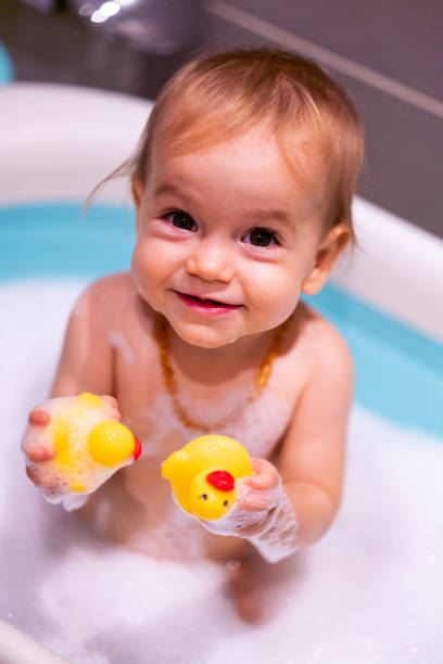 istock Happy baby girl is having a bath 1453950855