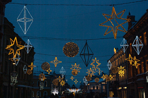 the evening city is decorated with garlands, glowing stars for the holiday