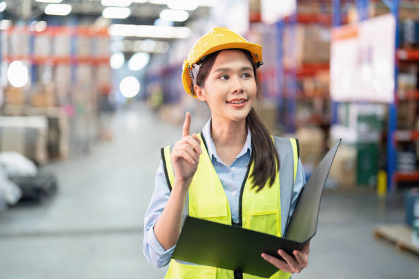 istock Staff working in large depot storage warehouse hold check list walking check goods on shelf 1453957247