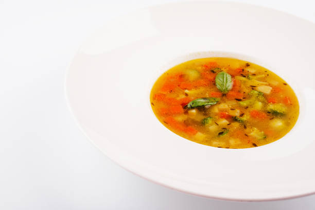Plate of chicken soup isolated on white