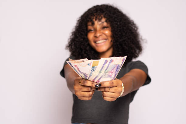 istock Attractive Black female holding money in her hands 1453961306