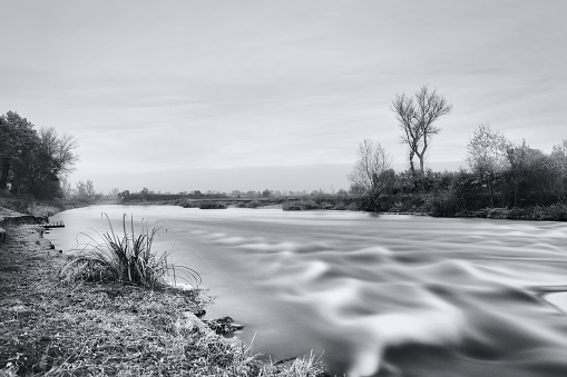 A wild river in wintertime. Long-exposure photo.