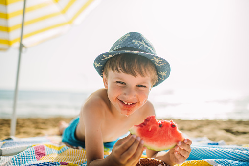 Little boy enjoying summer on the beach