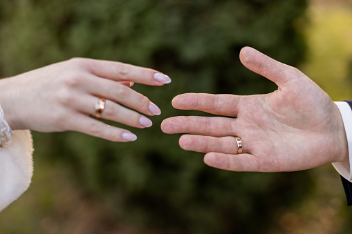 groom's hand and the bride's hand are held together