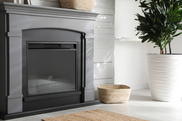 istock Modern electric fireplace near white wall indoors 1453969305